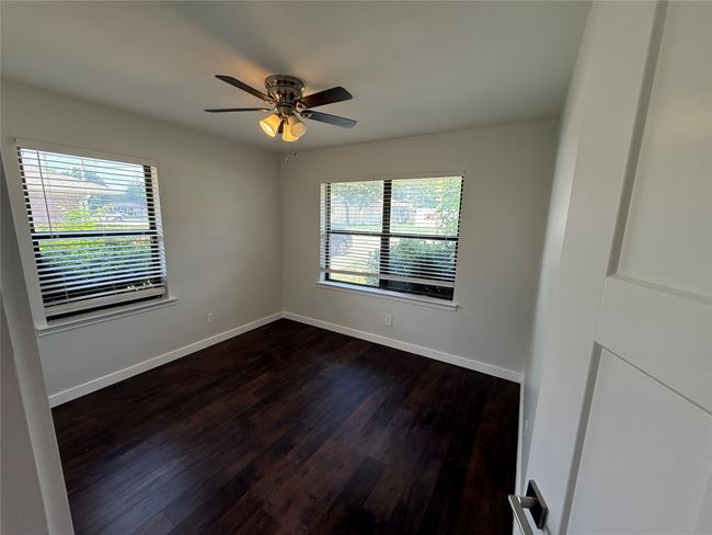 Empty room featuring dark wood-style floors and a ceiling fan | Image 10