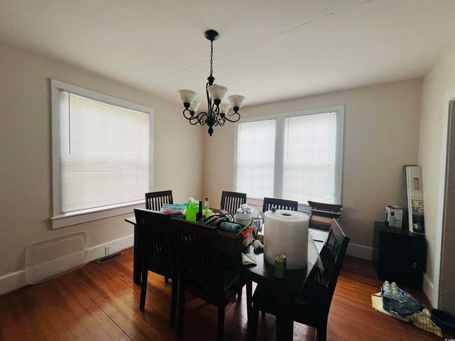 Dining room featuring baseboards, wood finished floors, and an inviting chandelier | Image 12