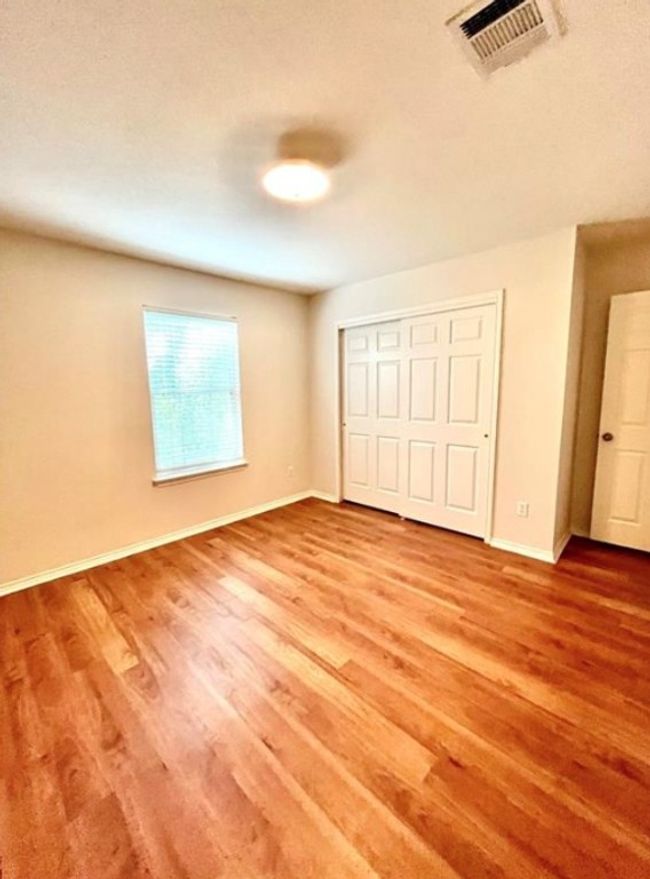 Unfurnished bedroom with light wood-type flooring, baseboards, and a closet | Image 13