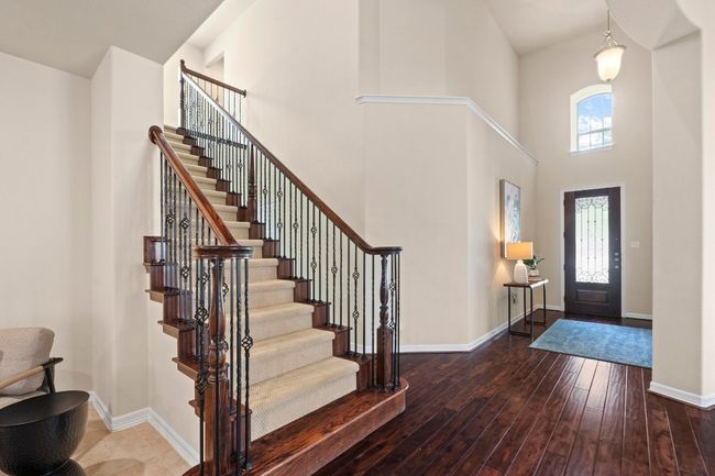 Entrance foyer with hardwood / wood-style floors, a high ceiling, and stairway | Image 26