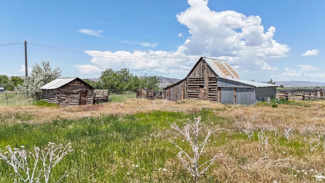 View of yard with a barn, an outdoor structure, a mountain view, and a rural view | Image 12