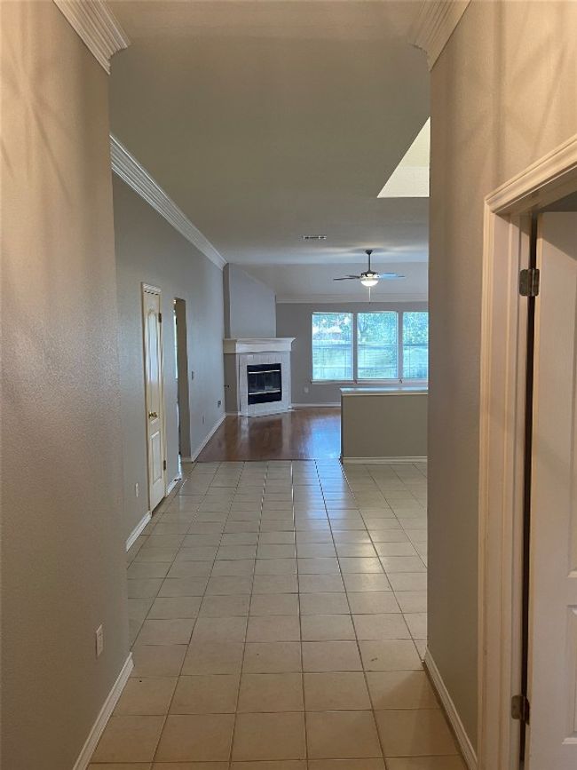 Corridor with light tile patterned floors and ornamental molding | Image 4