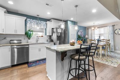 Kitchen island, granite counters and stainless steel appliances | Image 3