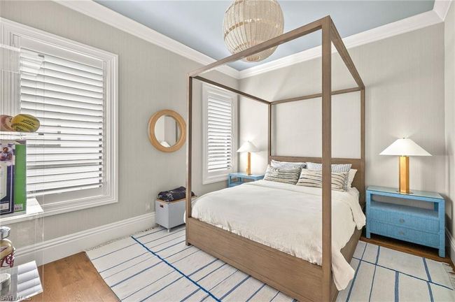 Bedroom with ornamental molding, wood finished floors, and baseboards | Image 30