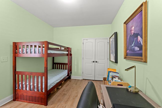 Bedroom with a closet, baseboards, and wood finished floors | Image 6