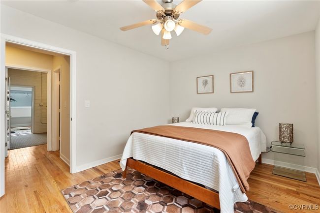Bedroom featuring light wood-style flooring and ceiling fan | Image 15