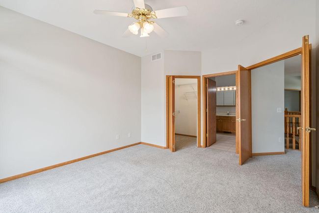 Large owner suite bedroom with spacious walk in closet, french doors, private on-suite bath with separate shower & soaking tub. | Image 12