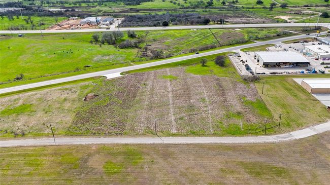 Aerial view of sparsely populated area featuring property parcel outlined | Image 7