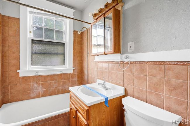 Bathroom featuring tile walls and vanity | Image 16