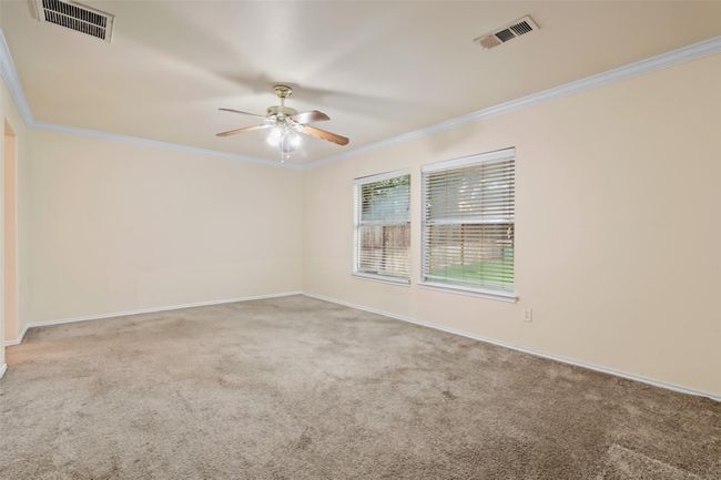 The primary bedroom can accommodate large furniture and a sitting. | Image 14