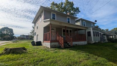 View of front of home with a front lawn and covered porch | Image 1