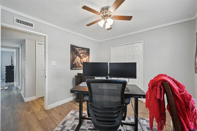 Office area with ceiling fan, wood finished floors, and crown molding | Image 20