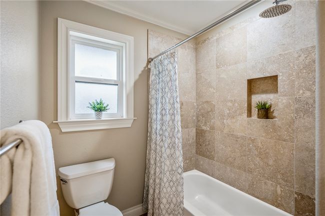 Bathroom featuring toilet and shower / bath combo with shower curtain | Image 26
