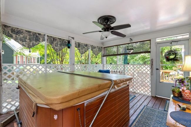 Sunroom featuring a hot tub and a ceiling fan | Image 39