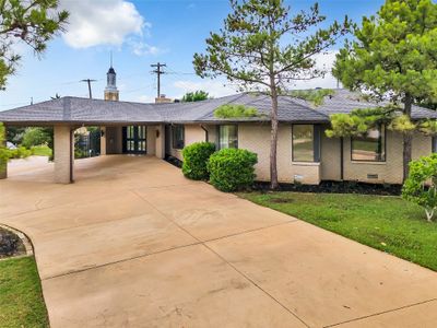 Single story home with a front yard and a carport | Image 1