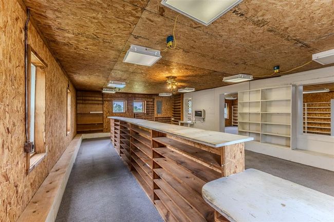 Bar area featuring dark carpet and a ceiling fan | Image 47