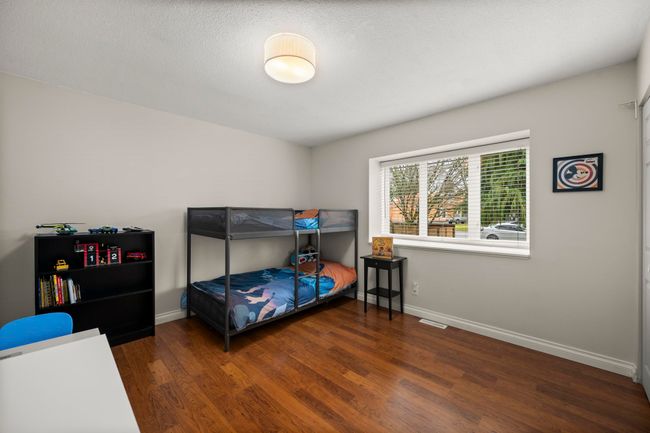 Bedroom with visible vents, baseboards, and wood finished floors | Image 25