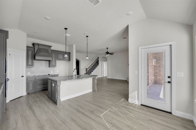 Kitchen featuring gray cabinetry, an island with sink and ss appliances | Image 16