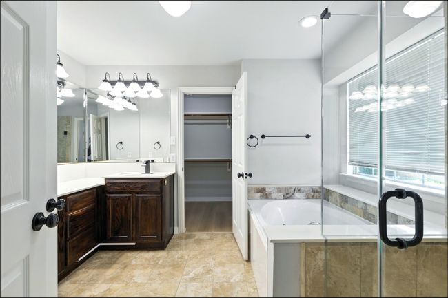 Full bathroom featuring vanity, a garden tub, and a spacious closet | Image 29
