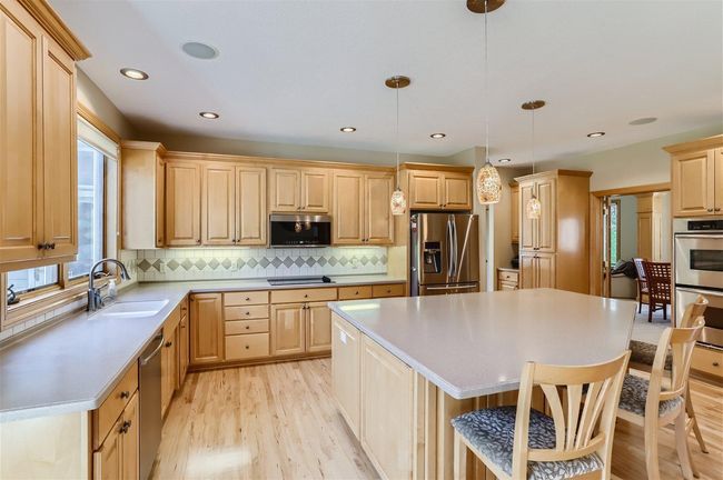 Plenty of counter space with the Corian counters & so much cabinet space, too! | Image 4