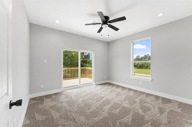 Spacious secondary bedroom with access to the balcony and lake views | Image 21