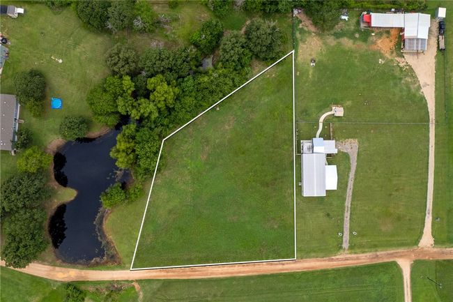 Aerial view of property and surrounding area with property parcel outlined and a nearby body of water | Image 5