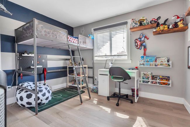Bedroom with wood finished floors and baseboards | Image 22