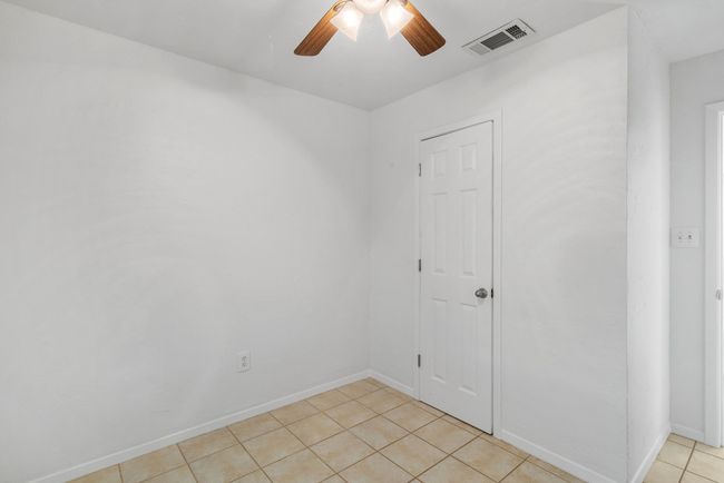 Spare room with light tile patterned floors and ceiling fan | Image 17