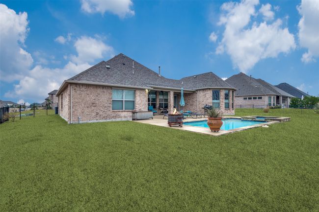 This fully bricked home is built on a spacious lot that is fully grassed and has an underground sprinkler system. | Image 28