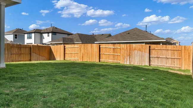 Fenced backyard with a residential view | Image 30