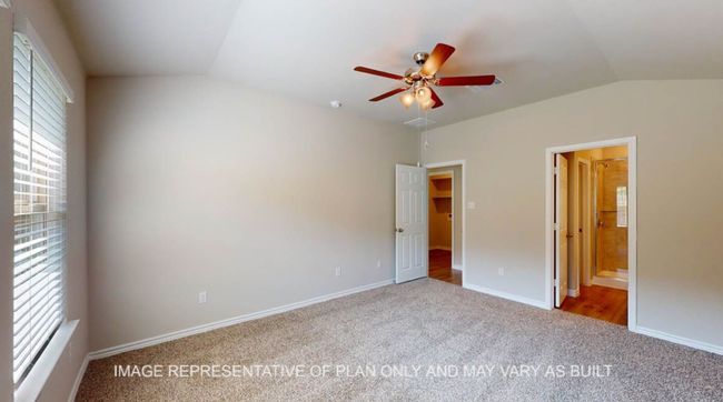 Unfurnished bedroom with vaulted ceiling, carpet floors, ensuite bathroom, baseboards, and ceiling fan | Image 13
