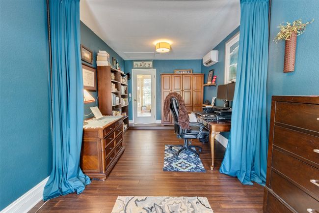 Home office featuring a wall mounted AC, dark wood-style floors, and baseboards | Image 10