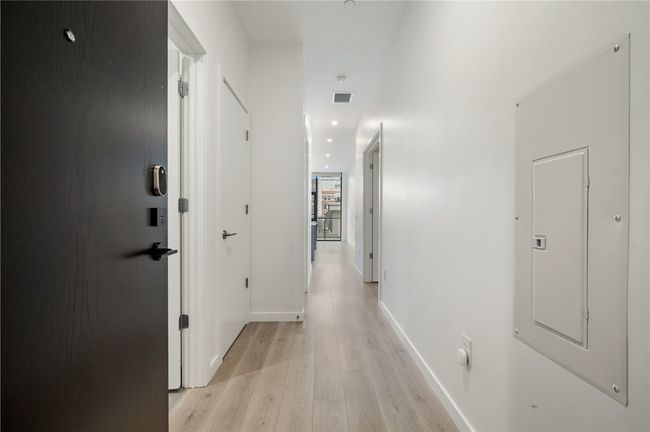 Half bath and guest bedroom on the left, primary suite on the right | Image 21