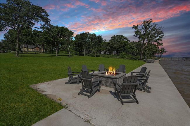 Patio terrace at dusk with a fire pit and a lawn | Image 33