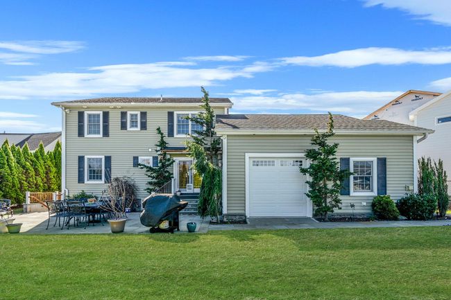 View of front of property with a patio, an attached garage, and a front lawn | Image 30