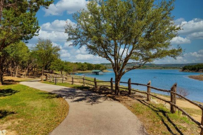 View of property's community with a water view and fence | Image 18