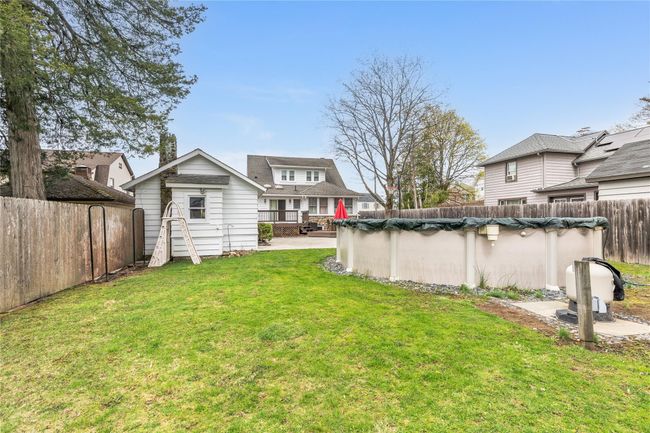 View of yard featuring a fenced backyard, an outbuilding, and a fenced in pool | Image 35