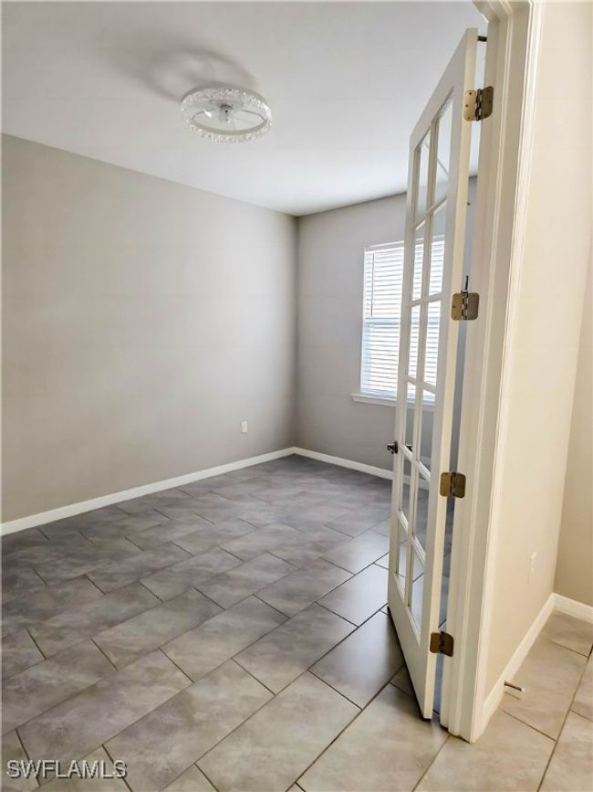 Unfurnished room featuring baseboards and light tile patterned floors | Image 6