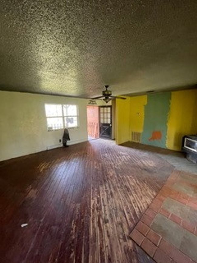 Unfurnished living room featuring a ceiling fan, a textured ceiling, and wood finished floors | Image 20