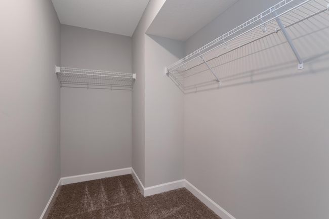 (Photo of decorated model, actual home's finishes will vary) The owner's suite features an incredible walk-in closet. | Image 15