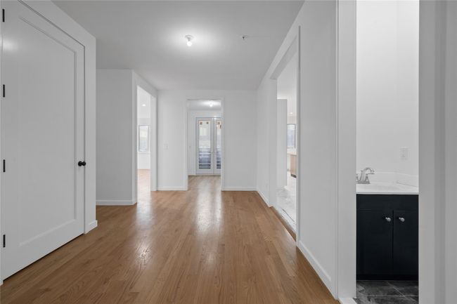 Corridor featuring a sink, light wood-style flooring, and baseboards | Image 13