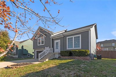 View of front facade with a front lawn and a garage | Image 2