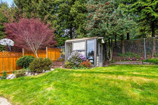 View of yard featuring an outbuilding, a fenced backyard, and a storage unit | Image 31