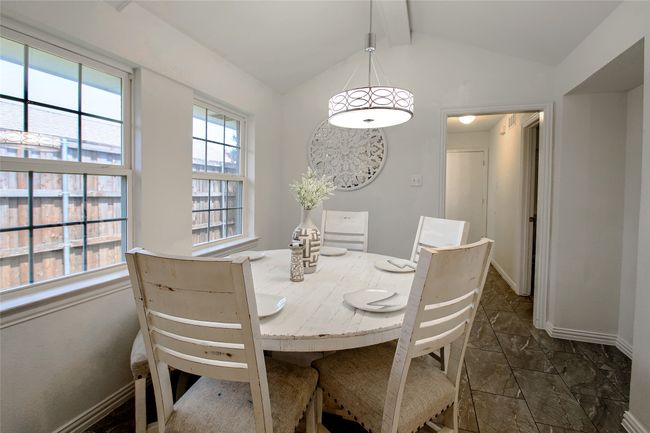 Dining space featuring baseboards and dark marble finish flooring | Image 15
