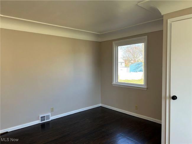 Living room featuring dark wood-type flooring and window. | Image 14