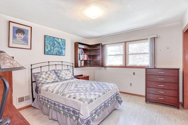 Bedroom featuring baseboards, visible vents, and light wood-type flooring | Image 21