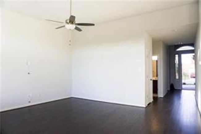 Unfurnished room featuring a ceiling fan and dark wood-style flooring | Image 16