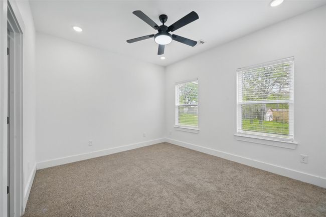 Carpeted spare room with ceiling fan, baseboards, visible vents, and recessed lighting | Image 16