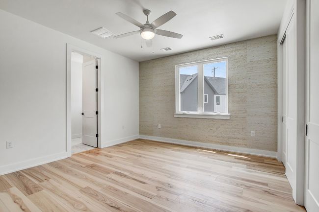 Empty room with baseboards, light wood-style floors, and ceiling fan | Image 13