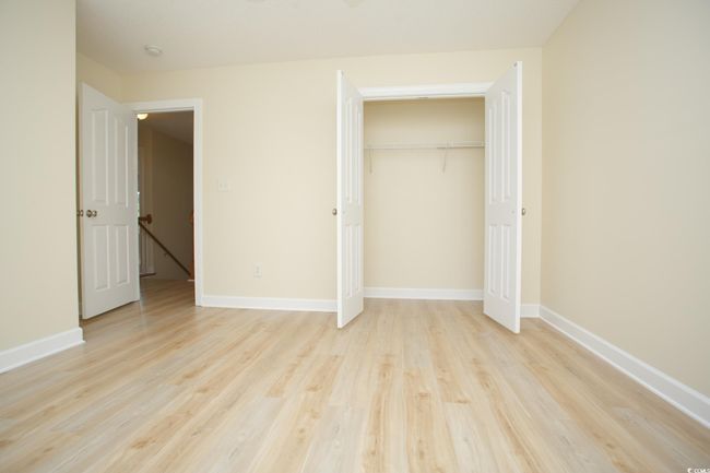 Unfurnished bedroom featuring light wood-style flooring, baseboards, and a closet | Image 27